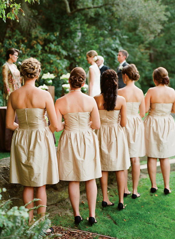 bridesmaids in short gold dresses watching ceremony - photo by San Francisco based wedding photographer Lisa Lefkowitz